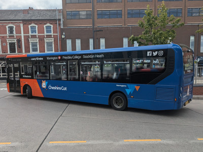 A blue bus branded 'The Cheshire Cat'